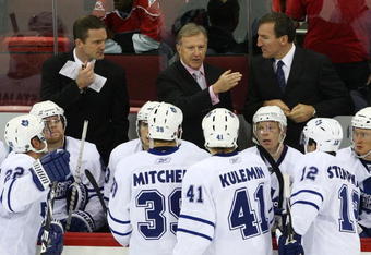 RALEIGH, NC - NOVEMBER 19: Hea Coach Ron Wilson (C) of the Toronto Maple Leafs gives his players instructions late in the third period in their game against the Carolina Hurricanes at the RBC Center on November 19, 2009 in Raleigh, North Carolina. The Hurricanes defeated the Maple Leafs 6-5 in the shoot out. (Photo by Bruce Bennett/Getty Images)
