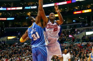 LOS ANGELES - NOVEMBER 26:  Marcus Camby #23 of the Los Angeles Clippers puts up a shot under pressure against Nene #31 of the Denver Nuggets during the game on November 26, 2008 at Staples Center in Los Angeles, California. The Nuggets won 106-105. NOTE TO USER: User expressly acknowledges and agrees that, by downloading and/or using this Photograph, user is consenting to the terms and conditions of the Getty Images License Agreement. (Photo by Jeff Gross/Getty Images)