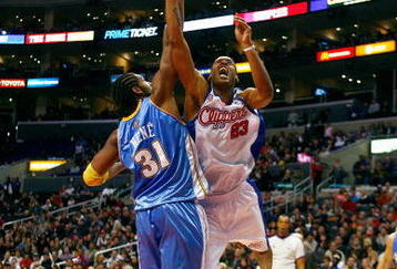 LOS ANGELES - NOVEMBER 26:  Marcus Camby #23 of the Los Angeles Clippers puts up a shot under pressure against Nene #31 of the Denver Nuggets during the game on November 26, 2008 at Staples Center in Los Angeles, California. The Nuggets won 106-105. NOTE TO USER: User expressly acknowledges and agrees that, by downloading and/or using this Photograph, user is consenting to the terms and conditions of the Getty Images License Agreement. (Photo by Jeff Gross/Getty Images)
