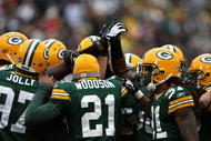GREEN BAY, WI - NOVEMBER 30:  (L-R) Johnny Jolly #97, Charles Woodson #21 and Al Harris #31 of the Green Bay Packers huddle up with their defensive teammates against the Carolina Panthers at Lambeau Field on November 30, 2008 in Green Bay, Wisconsin. The Panthers won 35-31.  (Photo by Jonathan Daniel/Getty Images)
