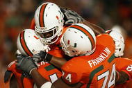 FORT LAUDERDALE, FL - OCTOBER 03: Wide receiver Travis Benjamin #3 of the Miami Hurricanes celebrates his touchdown with teammates Joel Figueroa #61 and Orlando Franklin #74 against the Oklahoma Sooners at Land Shark Stadium on October 3, 2009 in Fort Lauderdale, Florida. Miami defeated Oklahoma 21-20. (Photo by Doug Benc/Getty Images)