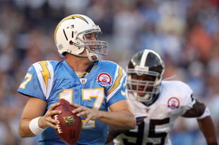 SAN DIEGO, CA - OCTOBER 19:  Quarterback Philip Rivers #17 of  the San Diego Chargers runs against the tackle of Darrell Reid #95 of the Denver Broncos during Monday Night Football on October 19, 2009 at Qualcomm Stadium in San Diego, California. (Photo by Donald Miralle/Getty Images)