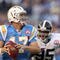 SAN DIEGO, CA - OCTOBER 19:  Quarterback Philip Rivers #17 of  the San Diego Chargers runs against the tackle of Darrell Reid #95 of the Denver Broncos during Monday Night Football on October 19, 2009 at Qualcomm Stadium in San Diego, California. (Photo by Donald Miralle/Getty Images)