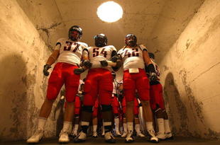 BERKELEY, CA - NOVEMBER 14:  Chris Gronkowski #37, Herman Hall #54 and Brooks Reed #42 of the Arizona Wildcats enter the field against the California Golden Bears at California Memorial Stadium on November 14, 2009 in Berkeley, California. (Photo by Jed Jacobsohn/Getty Images)