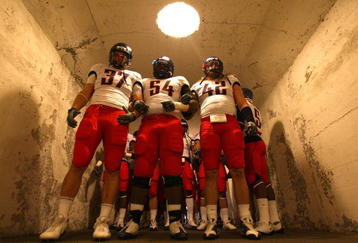 BERKELEY, CA - NOVEMBER 14:  Chris Gronkowski #37, Herman Hall #54 and Brooks Reed #42 of the Arizona Wildcats enter the field against the California Golden Bears at California Memorial Stadium on November 14, 2009 in Berkeley, California. (Photo by Jed Jacobsohn/Getty Images)