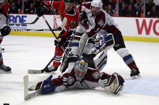 CHICAGO - NOVEMBER 11: Craig Anderson #41 of the Colorado Avalance sprawls to make a save as teammate Brett Clark #5 battles with Andrew Ebbett #15 of the Chicago Blackhawks at the United Center on November 11, 2009 in Chicago, Illinois. (Photo by Jonathan Daniel/Getty Images)