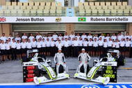 ABU DHABI, UNITED ARAB EMIRATES - NOVEMBER 01:  F1 Drivers Champion Jenson Button (L) of Great Britain poses with team mate Rubens Barrichello (R) of Brazil and the rest of his Constructors Championship Brawn GP colleagues for a team photo before the Abu Dhabi Formula One Grand Prix at the Yas Marina Circuit on November 1, 2009 in Abu Dhabi, United Arab Emirates.  (Photo by Getty Images)