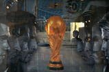 BEIJING, CHINA - JUNE 5: (CHINA OUT) An attendant is seen through a show window featuring football stars and the World Cup trophy at an adidas shop on June 5, 2006 in Beijing, China. Billboards and decorations featuring imagery relating to the World Cup, which starts June 9 in Germany, are being displayed on many Beijing streets as the event is seen as a great opportunity for local businesses, according to local media. (Photo by China Photos/Getty Images)