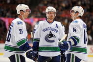 ANAHEIM, CA - OCTOBER 30:  Mikael Samuelsson #26, Henrik Sedin #33 and Alexandre Burrows #14 of the Vancouver Canucks confer during a break in game action against the Anaheim Ducks during their game at the Honda Center on October 30, 2009 in Anaheim, California. The Ducks defeated the Canucks 7-2.  (Photo by Harry How/Getty Images)