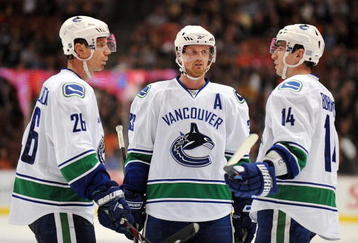 ANAHEIM, CA - OCTOBER 30:  Mikael Samuelsson #26, Henrik Sedin #33 and Alexandre Burrows #14 of the Vancouver Canucks confer during a break in game action against the Anaheim Ducks during their game at the Honda Center on October 30, 2009 in Anaheim, California. The Ducks defeated the Canucks 7-2.  (Photo by Harry How/Getty Images)
