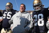 SOUTH BEND, IN - NOVEMBER 21: Head coach Charlie Weis of the Notre Dame Fighting Irish waits to enter the field with (L-R) Jimmy Clausen #7, Eric Olsen #55, Kyle McCarthy #28 and Scott Smith #41 before a game against the Univeristy of Connecticut Huskies at Notre Dame Stadium on November 21, 2009 in South Bend, Indiana. (Photo by Jonathan Daniel/Getty Images)