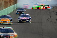 HOMESTEAD, FL - NOVEMBER 21:  (R) Brad Keselowski, driver of the #88 GoDaddy Chevrolet, spins out of control during the NASCAR Nationwide Series Ford 300 at Homestead-Miami Speedway on November 21, 2009 in Homestead, Florida.  (Photo by Todd Warshaw/Getty Images)