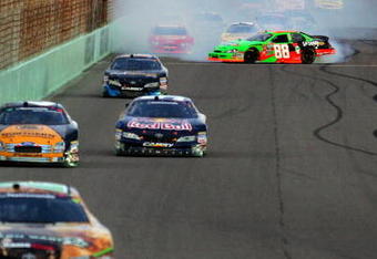 HOMESTEAD, FL - NOVEMBER 21:  (R) Brad Keselowski, driver of the #88 GoDaddy Chevrolet, spins out of control during the NASCAR Nationwide Series Ford 300 at Homestead-Miami Speedway on November 21, 2009 in Homestead, Florida.  (Photo by Todd Warshaw/Getty Images)