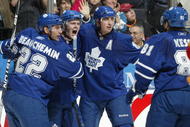 TORONTO,ON - NOVEMBER 14:  Matt Stajan #14 of the Toronto Maple Leafs celebrates his goal with teammates Francois Beauchemin #22 and Tomas Kaberle #15 in a game against the Calgary Flames on November 14,2009 at the Air Canada Centre in Toronto, Ontario, Canada. The Flames defeated the leafs 5-2. (Photo by Claus Andersen/Getty Images)