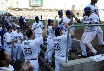LOS ANGELES, CA - OCTOBER 16:  Russell Martin #55 of the Los Angeles Dodgers is congratulated by his teammates as he entes the dugout after scoring the go-ahead run int he eighth inning against the Philadelphia Phillies in Game Two of the NLCS during the 2009 MLB Playoffs at Dodger Stadium on October 16, 2009 in Los Angeles, California.  (Photo by Kevork Djansezian/Getty Images)