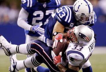 INDIANAPOLIS - NOVEMBER 15:  Melvin Bullitt #33 of the Indianapolis Colts tackles Kevin Faulk #33 of the New England Patriots short of a first down to gain possesion late in the fourth quarter of the game at Lucas Oil Stadium on November 15, 2009 in Indianapolis, Indiana. The Colts won the 35-34. (Photo by Jamie Squire/Getty Images)