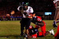 TUCSON, AZ - NOVEMBER 21:  Quarterback Jeremiah Masoli #8 of the Oregon Ducks rushes in the game winning touchdown in the second overtime past Earl Mitchell #49 and Xavier Kelley #15 of the Arizona Wildcats during the college football game at Arizona Stadium on November 21, 2009 in Tucson, Arizona. The Ducks defeated the Wildcats 44-41 in second overtime.  (Photo by Christian Petersen/Getty Images)