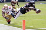 HOUSTON - OCTOBER 25:  Running back Steve Slaton #20 of the Houston Texans avoids a tackle by defensive tackle Isaac Sopoaga #90 of the San Francisco 49ers as he dives for the goaline for a touchdown at Reliant Stadium on October 25, 2009 in Houston, Texas.  (Photo by Bob Levey/Getty Images)