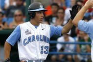 OMAHA, NE - JUNE 21: First baseman Dustin Ackley #13 of the North Carolina Tar Heels celebrates with teammates after hitting a solo homer in the second inning to the give the Tar Heels a 1-0 lead over the Rice Owls in Game 13 of the NCAA College World Series at Rosenblatt Stadium on June 21, 2007 in Omaha, Nebraska. (Photo by Kevin C. Cox/Getty Images)
