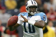 HOUSTON - DECEMBER 10:  Quarterback Vince Young #10 of the Tennessee Titans rolls out with the ball against the Houston Texans on December 10, 2006 at Reliant Stadium in Houston, Texas.  (Photo by Stephen Dunn/Getty Images)