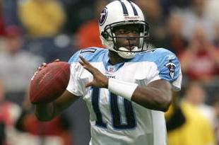 HOUSTON - DECEMBER 10: Quarterback Vince Young #10 of the Tennessee Titans rolls out with the ball against the Houston Texans on December 10, 2006 at Reliant Stadium in Houston, Texas. (Photo by Stephen Dunn/Getty Images)