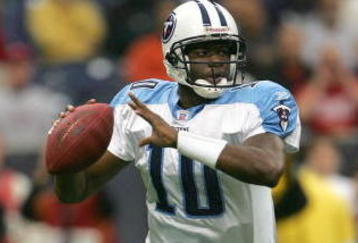 HOUSTON - DECEMBER 10:  Quarterback Vince Young #10 of the Tennessee Titans rolls out with the ball against the Houston Texans on December 10, 2006 at Reliant Stadium in Houston, Texas.  (Photo by Stephen Dunn/Getty Images)