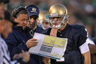 SOUTH BEND, IN - OCTOBER 17: Head coach Charlie Weis of the Notre Dame Fighting Irish gives a play to quarterback Jimmy Clausen #7 during a game against the USC Trojans at Notre Dame Stadium on October 17, 2009 in South Bend, Indiana. USC defeated Notre Dame 34-27. (Photo by Jonathan Daniel/Getty Images)