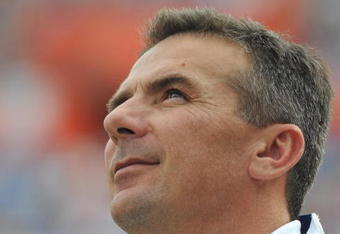 GAINESVILLE, FL - NOVEMBER 21: Coach Urban Meyer of the Florida Gators checks the scoreboard against the Florida International University Golden Panthers, November 21, 2009 at Ben Hill Griffin Stadium in Gainesville, Florida.  Florida won 62 - 3. (Photo by Al Messerschmidt/Getty Images)