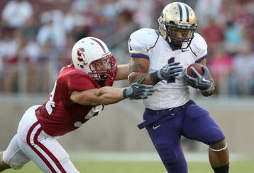 PALO ALTO, CA - SEPTEMBER 26:  Chris Polk #1 of the Washington Huskies runs against Thomas Keiser #94 of the Stanford Cardinal at Stanford Stadium on September 26, 2009 in Palo Alto, California.  (Photo by Jed Jacobsohn/Getty Images)