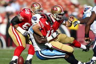 SAN FRANCISCO - NOVEMBER 08:  Alex Smith #11 of the San Francisco 49ers is tackled by William Hayes #95 of the Tennessee Titans during an NFL game on November 8, 2009 at Candlestick Park in San Francisco, California.  (Photo by Jed Jacobsohn/Getty Images)