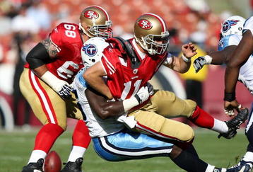 SAN FRANCISCO - NOVEMBER 08:  Alex Smith #11 of the San Francisco 49ers is tackled by William Hayes #95 of the Tennessee Titans during an NFL game on November 8, 2009 at Candlestick Park in San Francisco, California.  (Photo by Jed Jacobsohn/Getty Images)