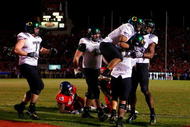 TUCSON, AZ - NOVEMBER 21:  Quarterback Jeremiah Masoli #8 of the Oregon Ducks is surrounded by teammtes in celebration after scoring the game winning touchdown in the second overtime against the Arizona Wildcats the college football game at Arizona Stadium on November 21, 2009 in Tucson, Arizona. The Ducks defeated the Wildcats 44-41 in second overtime. (Photo by Christian Petersen/Getty Images)