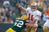 GREEN BAY, WI - NOVEMBER 22: Quarterback Alex Smith #11 of the San Francisco 49ers passes the football as he is hit by linebacker Clay Matthews #52 of the Green Bay Packers at Lambeau Field on November 22, 2009 in Green Bay, Wisconsin. (Photo by Scott Boehm/Getty Images)