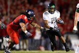 TUCSON, AZ - NOVEMBER 21:  Runningback LaMichael James #21 of the Oregon Ducks rushes the ball past Vuna Tuihalamaka #8 of the Arizona Wildcats during the college football game at Arizona Stadium on November 21, 2009 in Tucson, Arizona. The Ducks defeated the Wildcats 44-41 in second overtime.  (Photo by Christian Petersen/Getty Images)