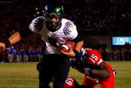 TUCSON, AZ - NOVEMBER 21:  Quarterback Jeremiah Masoli #8 of the Oregon Ducks rushes in the game winning touchdown in the second overtime past Earl Mitchell #49 and Xavier Kelley #15 of the Arizona Wildcats during the college football game at Arizona Stadium on November 21, 2009 in Tucson, Arizona. The Ducks defeated the Wildcats 44-41 in second overtime.  (Photo by Christian Petersen/Getty Images)