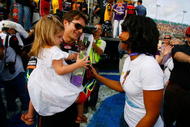 HOMESTEAD, FL - NOVEMBER 22:  Jeff Gordon, driver of the #24 DuPont Chevrolet, holds his daughter Ella Sophia, as they talk with actress Anika Noni Rose before the NASCAR Sprint Cup Series Ford 400 at Homestead-Miami Speedway on November 22, 2009 in Homestead, Florida.  (Photo by Jason Smith/Getty Images for NASCAR)