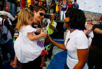 HOMESTEAD, FL - NOVEMBER 22:  Jeff Gordon, driver of the #24 DuPont Chevrolet, holds his daughter Ella Sophia, as they talk with actress Anika Noni Rose before the NASCAR Sprint Cup Series Ford 400 at Homestead-Miami Speedway on November 22, 2009 in Homestead, Florida.  (Photo by Jason Smith/Getty Images for NASCAR)