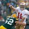 GREEN BAY, WI - NOVEMBER 22: Quarterback Alex Smith #11 of the San Francisco 49ers passes the football as he is hit by linebacker Clay Matthews #52 of the Green Bay Packers at Lambeau Field on November 22, 2009 in Green Bay, Wisconsin. (Photo by Scott Boehm/Getty Images)