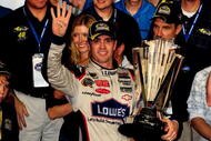 HOMESTEAD, FL - NOVEMBER 22:  Jimmie Johnson, driver of the #48 Lowe's Chevrolet, celebrates after winning the NASCAR Sprint Cup Series Championship after finishing in fifth place in the Ford 400 at Homestead-Miami Speedway on November 22, 2009 in Homestead, Florida. Johnson becomes the first driver in the history of NASCAR to win four consecutive championships since the sports inception in 1949.during the NASCAR Sprint Cup Series Ford 400 at Homestead-Miami Speedway on November 22, 2009 in Homestead, Florida.  (Photo by Sam Greenwood/Getty Images)
