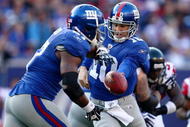 EAST RUTHERFORD, NJ - NOVEMBER 22:  Eli Manning #10 of the the New York Giants hands off to team mate Brandon Jacobs #27 against the Atlanta Falcons on November 22, 2009 at Giants Stadium in East Rutherford, New Jersey.  (Photo by Chris McGrath/Getty Images)