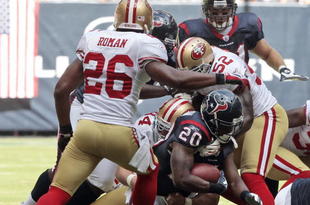 HOUSTON - OCTOBER 25:  Running back Steve Slaton #20 of the Houston Texans is tackled by linebacker Patrick Willis #52 and Mark Roman #26 of the San Francisco 49ers at Reliant Stadium on October 25, 2009 in Houston, Texas.  (Photo by Bob Levey/Getty Images)