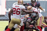 HOUSTON - OCTOBER 25:  Running back Steve Slaton #20 of the Houston Texans is tackled by linebacker Patrick Willis #52 and Mark Roman #26 of the San Francisco 49ers at Reliant Stadium on October 25, 2009 in Houston, Texas.  (Photo by Bob Levey/Getty Images)