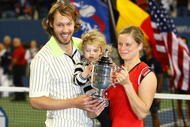 NEW YORK - SEPTEMBER 13:  Kim Clijsters of Belgium poses with the championship trophy alongside husband Brian Lynch and daughter Jada after defeating Caroline Wozniacki of Denmark in the Women�s Singles final on day fourteen of the 2009 U.S. Open at the USTA Billie Jean King National Tennis Center on September 13, 2009 in the Flushing neighborhood of the Queens borough of New York City. Clijsters defeated Wozniacki 7-5, 6-3.  (Photo by Julian Finney/Getty Images)