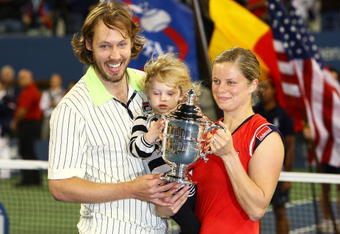 NEW YORK - SEPTEMBER 13:  Kim Clijsters of Belgium poses with the championship trophy alongside husband Brian Lynch and daughter Jada after defeating Caroline Wozniacki of Denmark in the Women�s Singles final on day fourteen of the 2009 U.S. Open at the USTA Billie Jean King National Tennis Center on September 13, 2009 in the Flushing neighborhood of the Queens borough of New York City. Clijsters defeated Wozniacki 7-5, 6-3.  (Photo by Julian Finney/Getty Images)