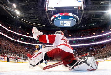 MONTREAL- NOVEMBER 21:  Jimmy Howard #35 of the Detroit Red Wings stretches out to stop the puck on the shootout attempt by Mike Cammalleri #13 of the Montreal Canadiens during the NHL game on November 21, 2009 at the Bell Centre in Montreal, Quebec, Canada.  The Red Wings defeated the Canadiens 3-2 in a shootout.  (Photo by Richard Wolowicz/Getty Images)