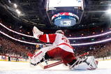 MONTREAL- NOVEMBER 21:  Jimmy Howard #35 of the Detroit Red Wings stretches out to stop the puck on the shootout attempt by Mike Cammalleri #13 of the Montreal Canadiens during the NHL game on November 21, 2009 at the Bell Centre in Montreal, Quebec, Canada.  The Red Wings defeated the Canadiens 3-2 in a shootout.  (Photo by Richard Wolowicz/Getty Images)