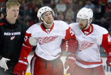 MONTREAL- NOVEMBER 21:  Niklas Kronwall #55 of the Detroit Red Wings is helped off of the ice after being tripped by Georges Laraque #17 of the Montreal Canadiens during the NHL game on November 21, 2009 at the Bell Centre in Montreal, Quebec, Canada.  (Photo by Richard Wolowicz/Getty Images)