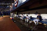 MINNEAPOLIS - OCTOBER 9:  Some Minnesota Twins players sit on the bench and watch s the New York Yankees celebrate on the field after defeating the Twins during game four of the American League Divisional Series at the Hubert H. Humphrey Metrodome on October 9, 2004 in Minneapolis, Minnesota.The Yankees defeated the Twins 6-5 to advance to the American League Championship Series against the Boston Red Sox. (Photo by Jed Jacobsohn/Getty Images)