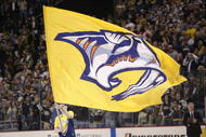 NASHVILLE - APRIL 13:  A Nashville Predators flag is paraded around the rink during a break in game four of the first round of the  2004 Stanley Cup playoffs against the Detroit Red Wings on April 13, 2004 at the Gaylord Center in Nashville, Tennessee. (Photo by Brian Bahr/Getty Images)
