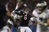 CHICAGO - NOVEMBER 22: Jay Cutler #6 of the Chicago Bears is hit by Quintin Mikell #27 of the Philadelphia Eagles as Cutler throws a 15-yard touchdown in the third quarter at Soldier Field on November 22, 2009 in Chicago, Illinois.  (Photo by Jonathan Daniel/Getty Images)